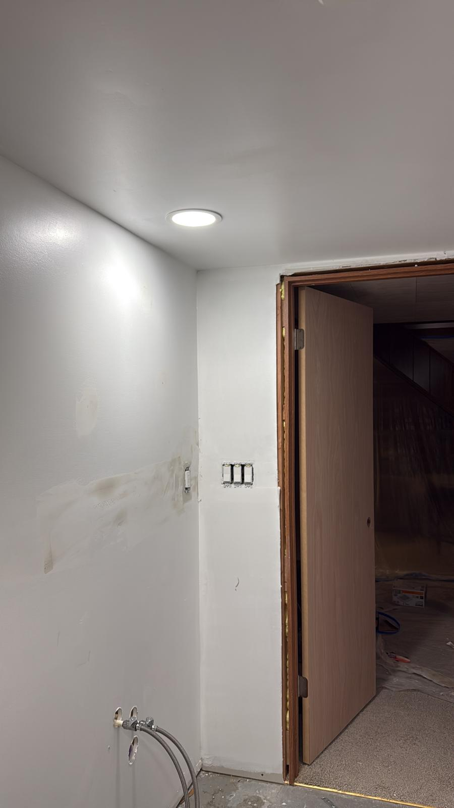 Freshly painted white interior walls and ceiling with new door hung