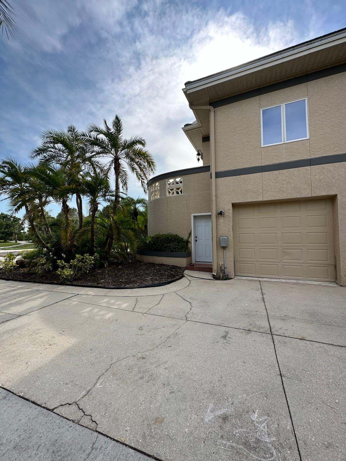 Side garage elevation with palms before exterior repaint