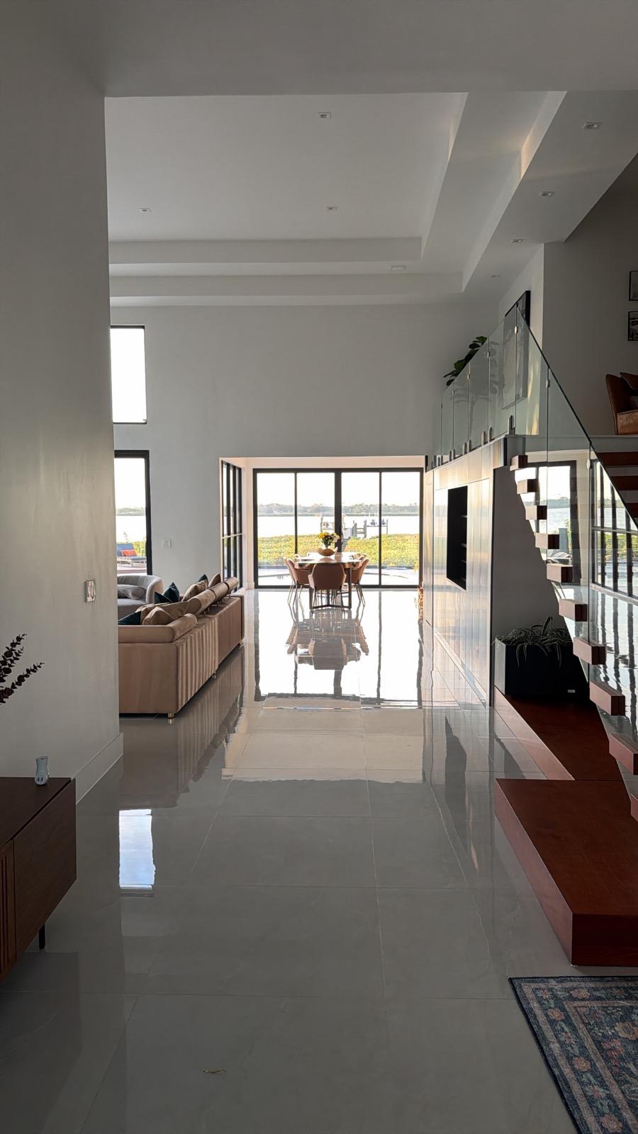 Polished large-format porcelain floor running through an open living and dining area