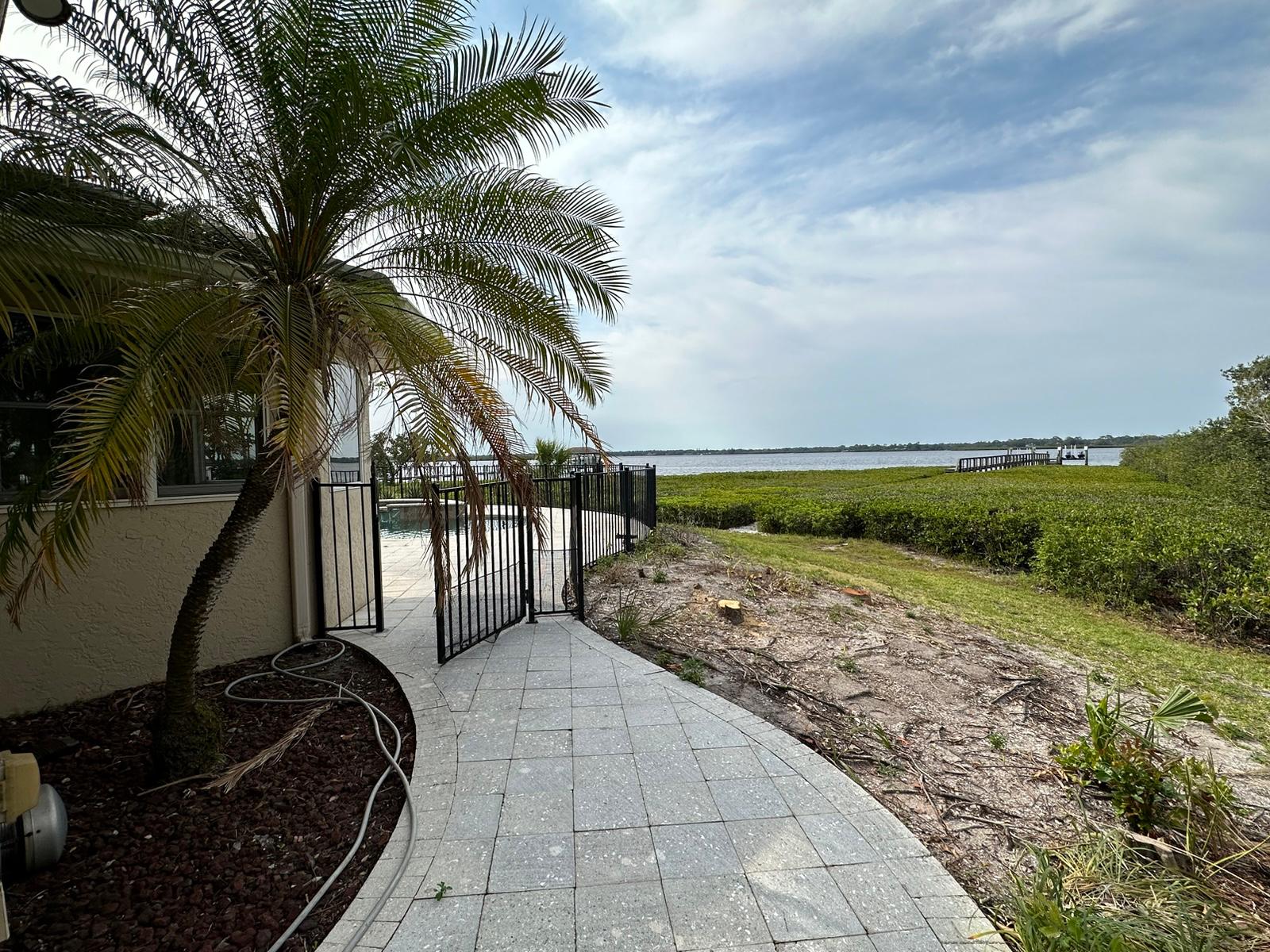 Paver walkway along the home to the waterfront before landscaping