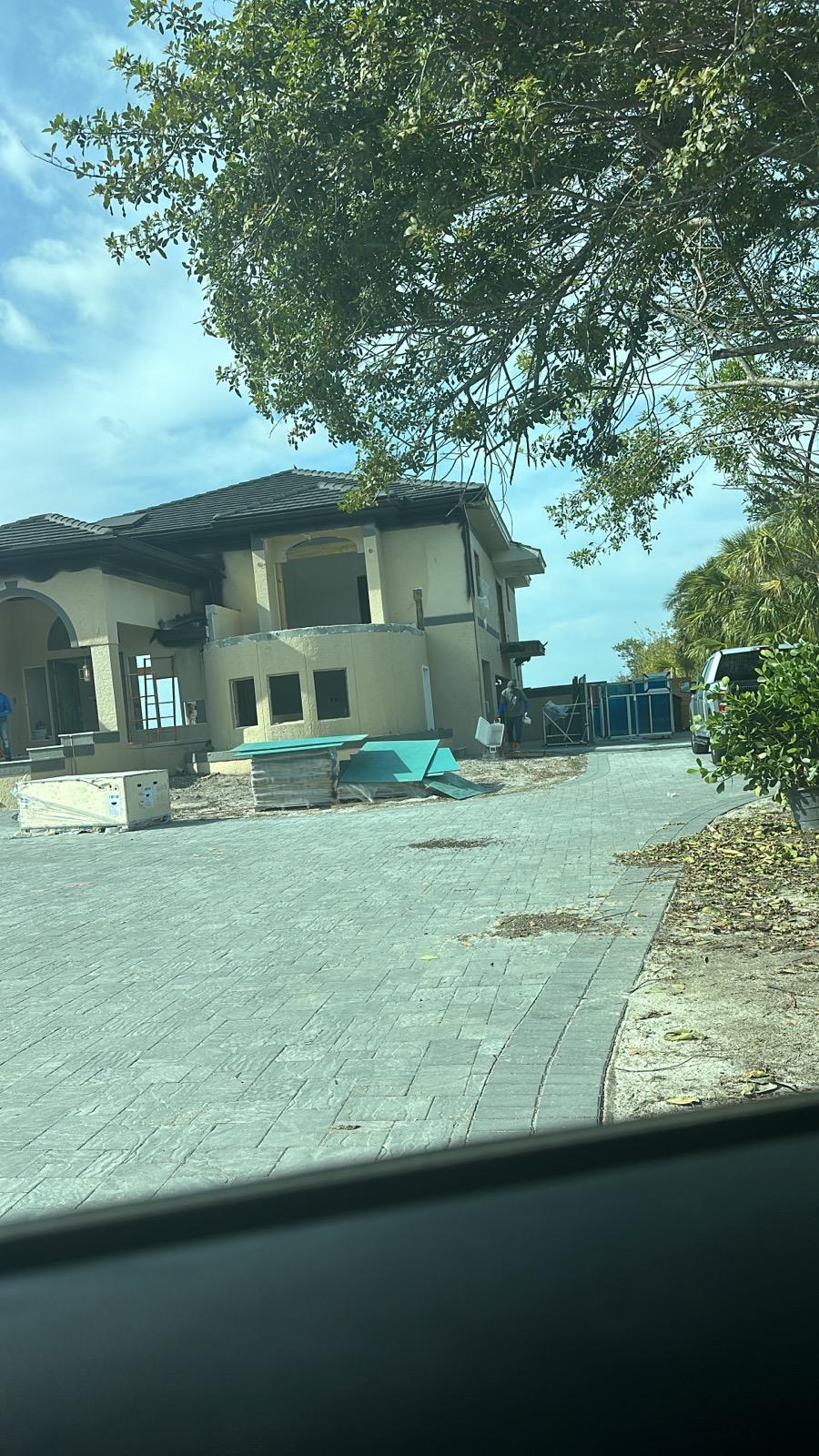 Jobsite with materials staged in front of a home under renovation