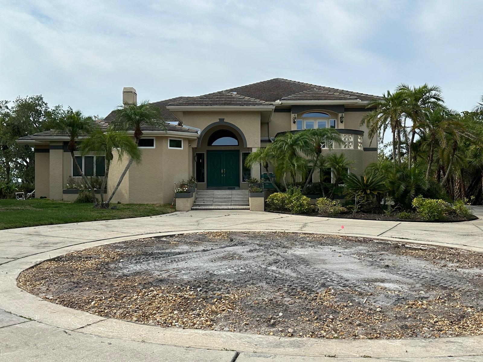 Front elevation with worn circular driveway island before rebuild